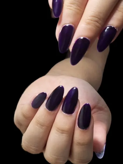 A deep and mysterious dark purple. This glossy, jewel-toned polish looks incredibly chic on long, almond-shaped nails.