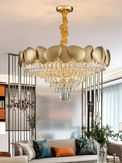 A modern crystal chain chandelier with a round gold frame. This fixture is perfect for contemporary living rooms, offering a stylish blend of metallic shine and crystalline sparkle.