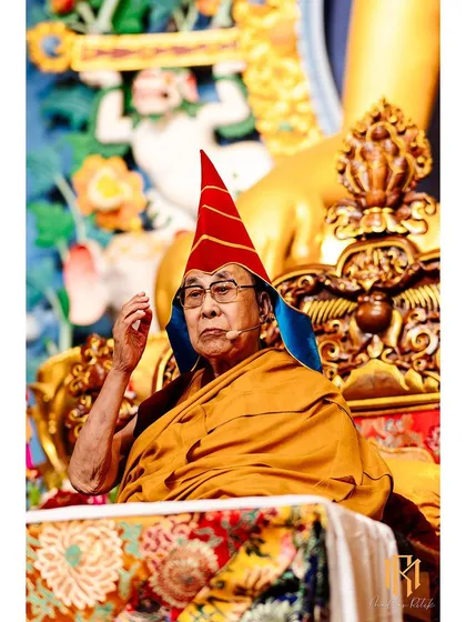 A close-up portrait of His Holiness the Dalai Lama during a teaching session in Bodh Gaya. Capturing such moments requires anticipation and discretion, ensuring the sanctity of the event is maintained while documenting its key figures.