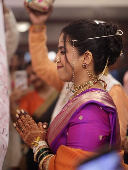 A side view of the bride during a ceremony, showing her simple yet beautiful henna.