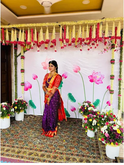 A full-length shot of the bride at her Pellikuthuru ceremony. The entire look, from the saree to the makeup, is a celebration of color and tradition.