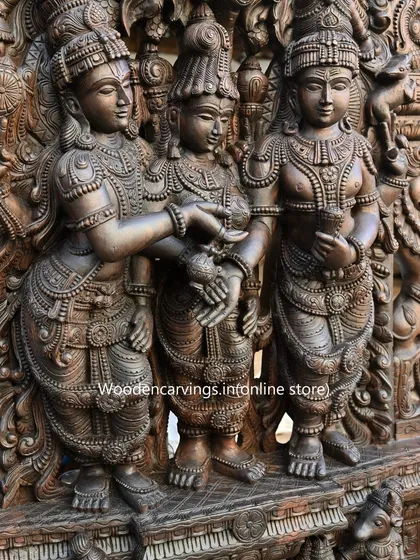 Another perspective on the central figures of the 87-inch Meenakshi Thirukalyanam piece. This angle highlights the three-dimensional quality of the carving and the careful composition that draws the viewer into the sacred ceremony.