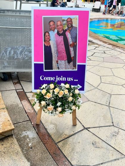 Directional signs with photos help guide guests through the venue while adding a personal touch to the event.