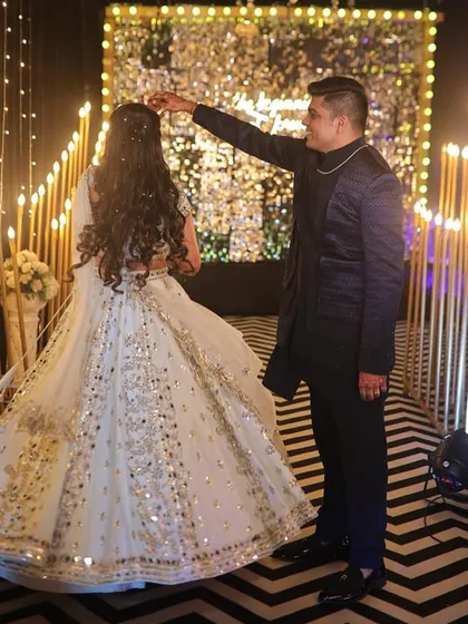 A romantic dance moment from the sangeet. The bride's makeup, with its minimalist glamour, looks stunning under the party lights.