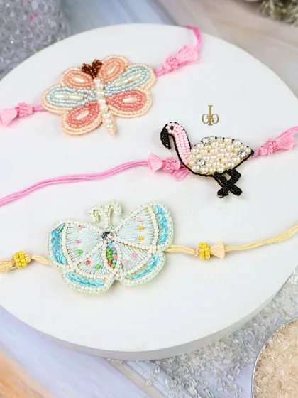 Our collection of beaded weave Rakhis for sisters (Lumbas), featuring intricate designs like butterflies and flamingos.