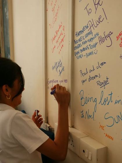 "Being lost in a book." A volunteer shares what happiness means to her on our office wall.