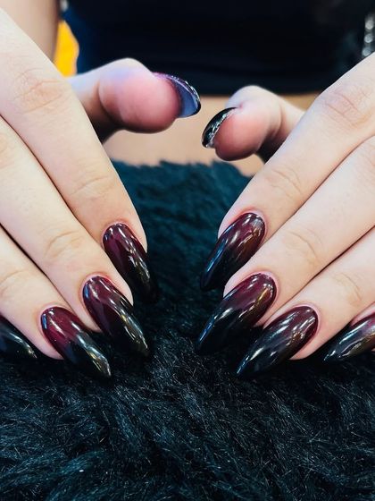 Dark and dramatic. This look features a seamless ombré blend from a deep burgundy to black on long, almond-shaped nails. The glossy finish makes the colors look rich and intense.