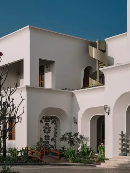 A wider architectural shot showcasing how our intricate mosaic art integrates with the building's facade, creating a dialogue between the handcrafted details and the modern structure.