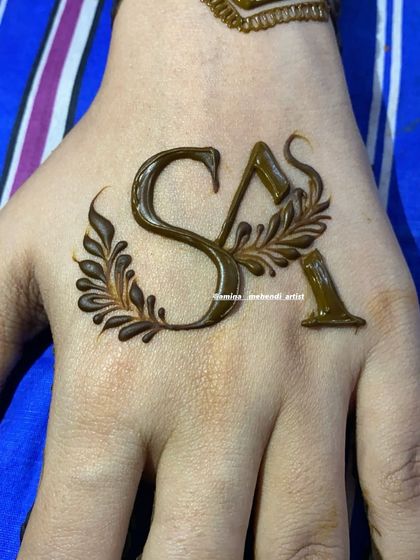 A close-up of custom initials 'S' and 'A' with a delicate leafy design, perfect for a minimalist touch.