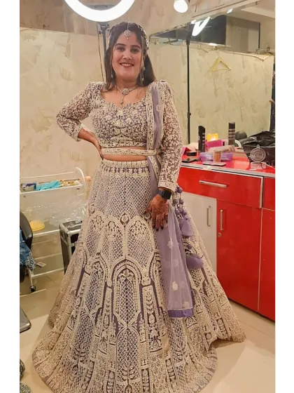A client looking radiant in a lavender-grey lehenga with detailed white threadwork. This photo was taken in my studio, showing the final look with makeup and jewellery.