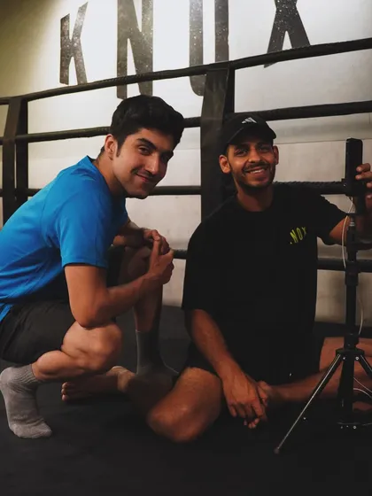 Two members posing for a photo in the ring after a session. The atmosphere at Knox is supportive and fun.