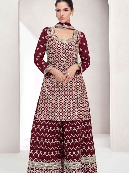 This maroon Chinon silk palazzo suit is perfect for a winter wedding. The heavy thread embroidery and sequins add a festive sparkle.