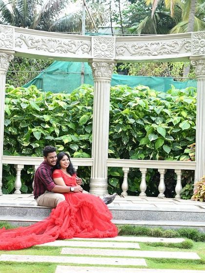 Another angle of the beautiful garden gazebo set, showing the couple sharing a quiet moment together. The long train of the red dress adds a dramatic flair.