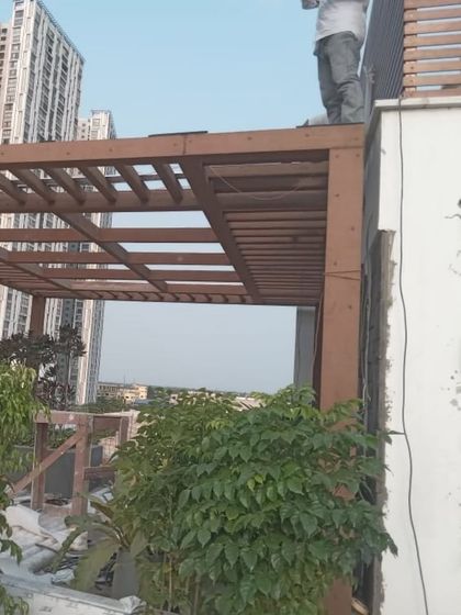 Our team at work installing a custom pergola on a high-rise terrace. This behind-the-scenes shot shows the precision and care that goes into every installation.