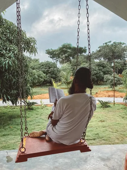 I take a quiet moment to read on a swing overlooking the ashram grounds. Personal time for study and reflection is an important part of the balanced life we cultivate here.