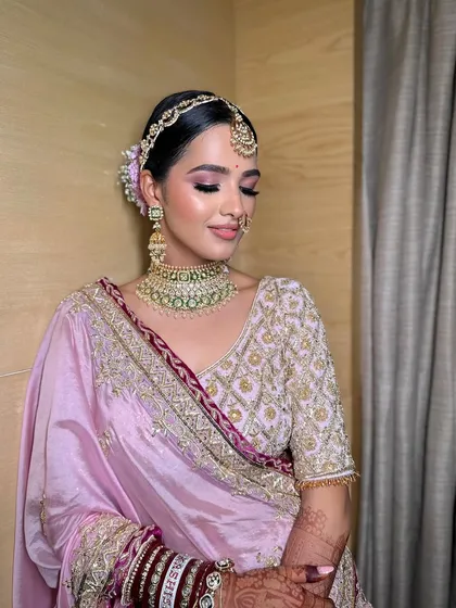 The complete look for Mahek's pheras, showing how the makeup harmonizes with her pastel pink and purple lehenga and traditional jewelry.