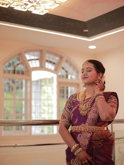 Madhu's serene expression and elegant posture highlight the beauty of her traditional attire.