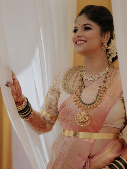 A beautiful, happy smile from Gagana at her post-wedding reception. The makeup is designed to look fresh and radiant, even after a long day of ceremonies.