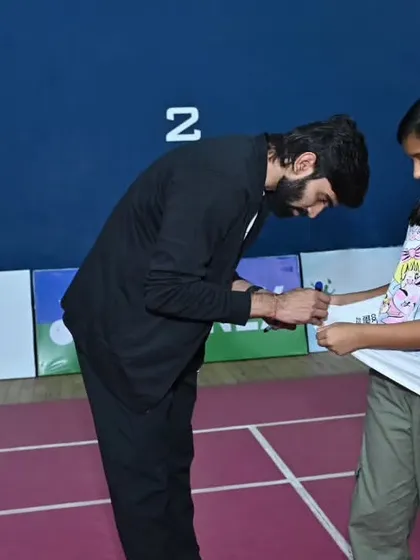 A young fan gets her t-shirt signed by Srikanth Kidambi. We facilitate player and fan interactions to make our events more engaging.