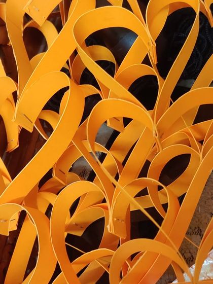 A close up of the saffron colored paper hearts, ready to become part of the tiranga.