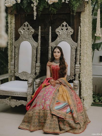 The bride seated on her ceremonial throne, her long, wavy hair cascading beautifully over her shoulders.