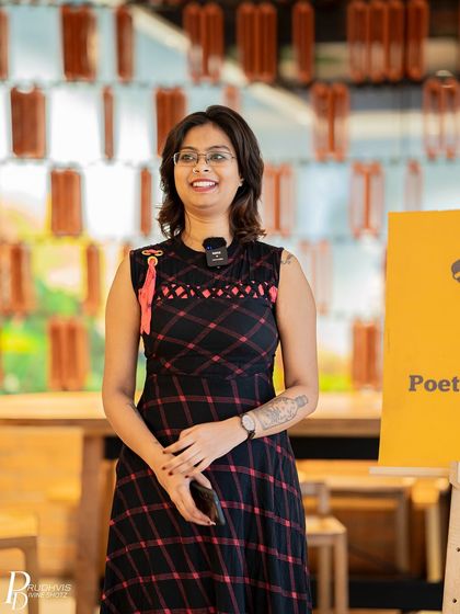 A smiling performer at our "Vulnerabilities" event. The community came together to celebrate literature and the courage to be vulnerable.