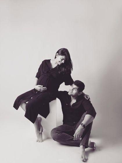 A beautifully composed black and white shot of the couple. The different levels and loving looks create a dynamic yet intimate portrait that feels both artistic and authentic.