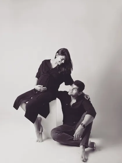 A beautifully composed black and white shot of the couple. The different levels and loving looks create a dynamic yet intimate portrait that feels both artistic and authentic.