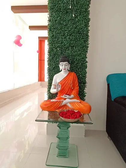 I also create serene indoor spaces. This design for a spa features a Buddha statue on a glass table against a vertical green wall, establishing a peaceful and welcoming ambiance.