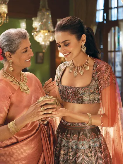 This shot from the Tanishq 'Dharohar' campaign tells a story of heritage passed down through generations. The styling connects a mother and daughter through coordinated color palettes and traditional jewellery, creating a moment of warmth and connection.