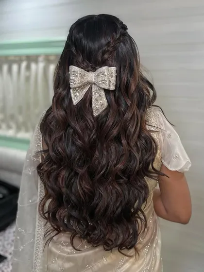 A detailed shot of the embellished bow, showing the craftsmanship that goes into these beautiful accessories. It's the perfect finishing touch for a special occasion hairstyle.