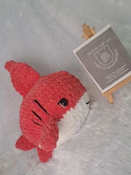 A 10-inch red plush shark toy.