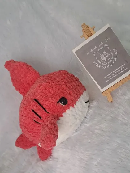 A 10-inch red plush shark toy.