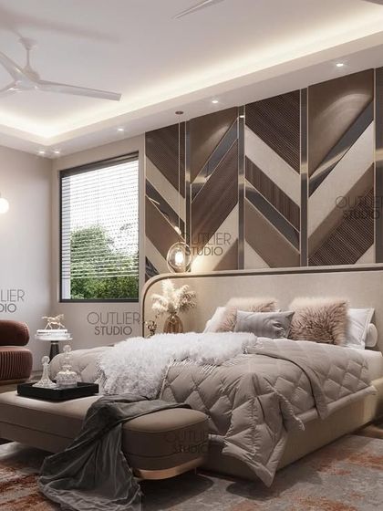 The perfect retreat after a long day at work. This bedroom features a stunning chevron-patterned wood and mirror wall, a comfortable bed, and a gallery wall of personal photos, creating a space that is both stylish and personal.