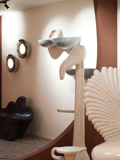 Our Nature's Alchemy collection on display, featuring a variety of sculptural pieces. The scene includes our winged Pakhru chair, cactus lamps, and other art pieces that transform a space with their unique forms.