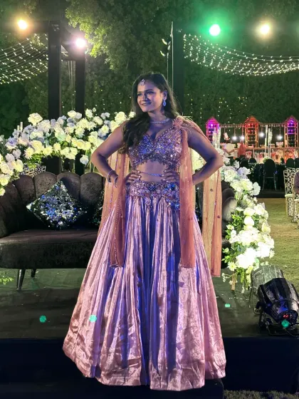 Posing on the stage seating before the Sangeet night begins, showcasing my glamorous outfit for the evening.