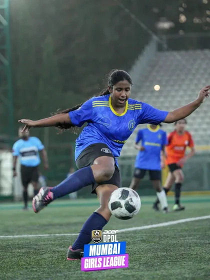 A powerful shot of a female player striking the ball mid-air during a competitive match. This image captures the dynamism and skill of our players in the Mumbai Girls League.