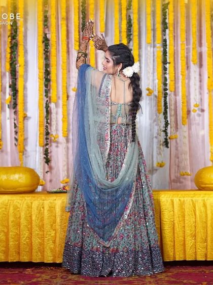 The back view of this floral Mehendi lehenga shows off the pretty details and the flowy fabric. It's an outfit made for dancing and celebrating.