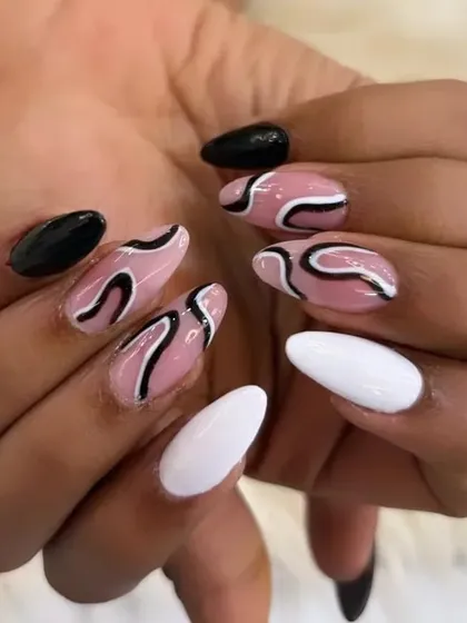This image captures the dynamic and modern feel of the abstract swirl design, a popular choice for those looking for unique and stylish nail art.