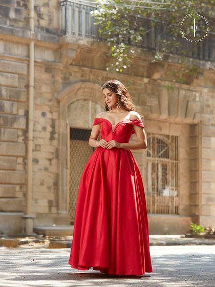 The full view of this stunning red gown in a beautiful outdoor setting. Imagine the photos you'll take in this rental.