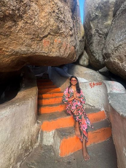 Sitting on the steps leading up to a cave temple in Hampi.