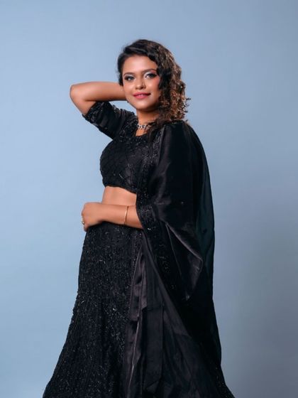The final look for this bridesmaid: a stunning black lehenga paired with a silver smokey eye and bouncy curls.