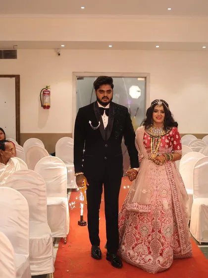 The couple's grand entrance. The bride's makeup is designed to be impactful from a distance and flawless up close.