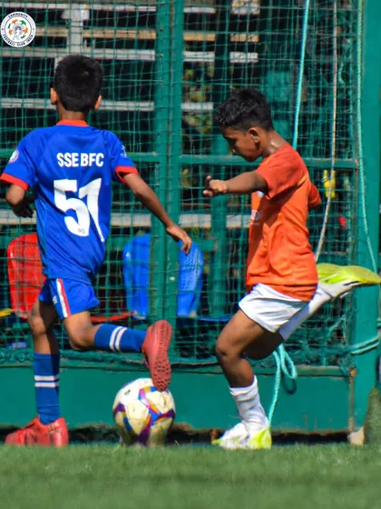A player dribbles past an opponent during a competitive U13 match. We focus on developing 1v1 skills and confidence.