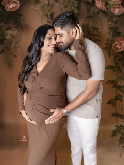 Warm, earthy tones for a cozy and intimate studio maternity shoot. The mom-to-be looks so serene and happy in her partner's arms.