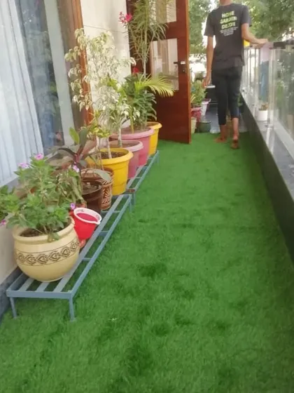 A happy client on their newly transformed green balcony.