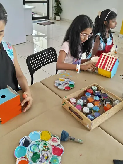 Kids at a birthday party are busy painting and assembling their own wooden birdhouses. We provide a wide range of colors for them to choose from.