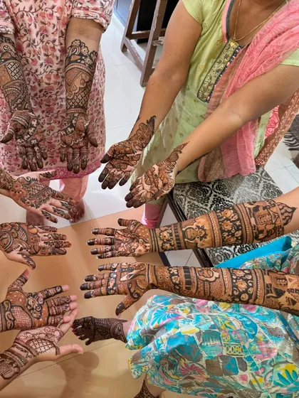 A beautiful shot of all the ladies at the baby shower showing their mehndi designs.