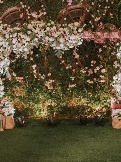 We created an enchanting garden setting for this post-wedding soiree. The floral arch, set against a wall of lush greenery, served as a beautiful photo backdrop and focal point for the evening's celebrations.