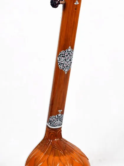 Another view of the floral tanpura, showing the decorative elements on the neck.